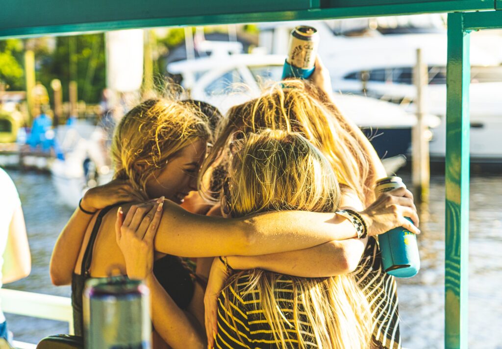 Friends hugging on Paddle Pub